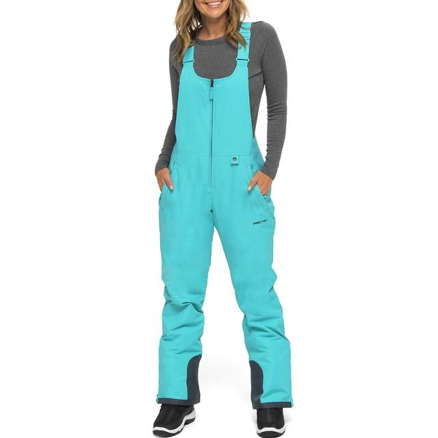 woman wearing blue bird  Arctix black snow bibs