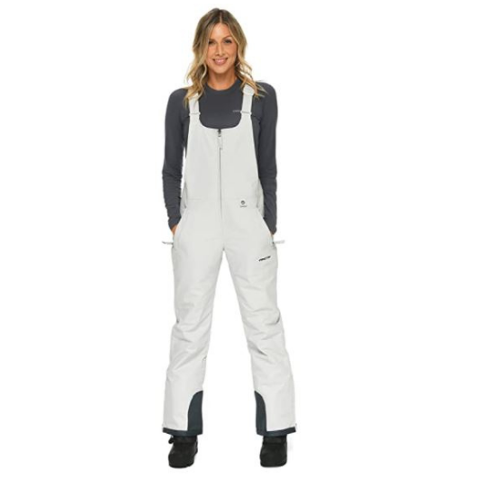 Front view of woman wearing Arctix snow bibs in Quiet Gray