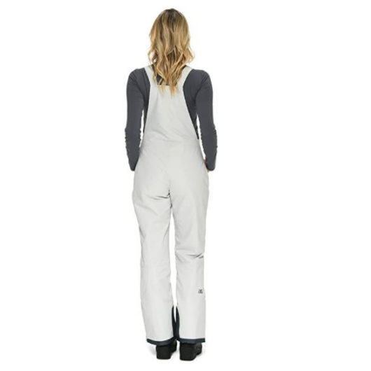 Back view of woman wearing Arctix snow bibs in Quiet Gray