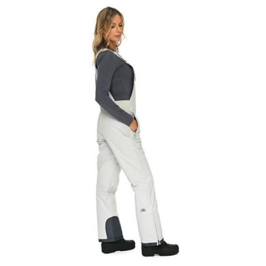 Right side view of woman wearing Arctix snow bibs in Quiet Gray