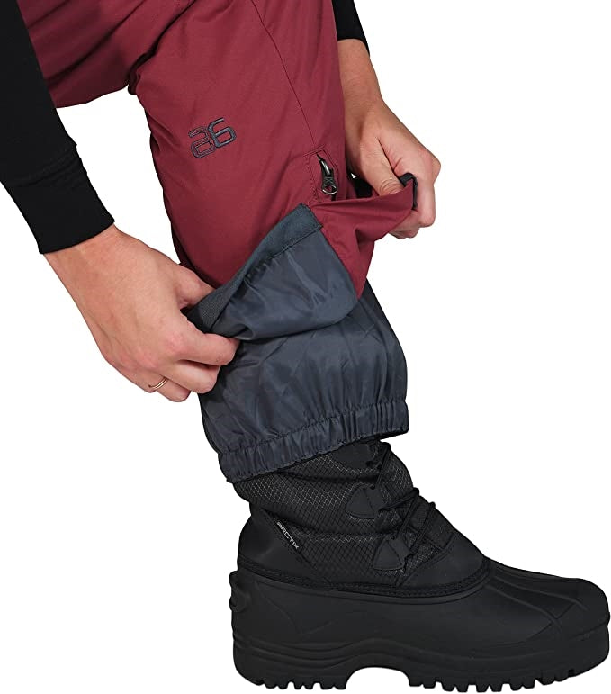 Pants view of woman wearing Arctix snow bibs in crimson