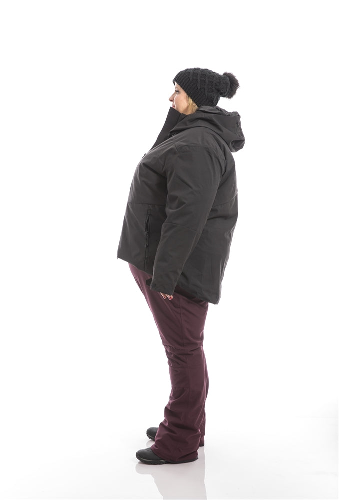 Kindra wearing a Swiss System 3 in one jacket over Groove Bibs left side view