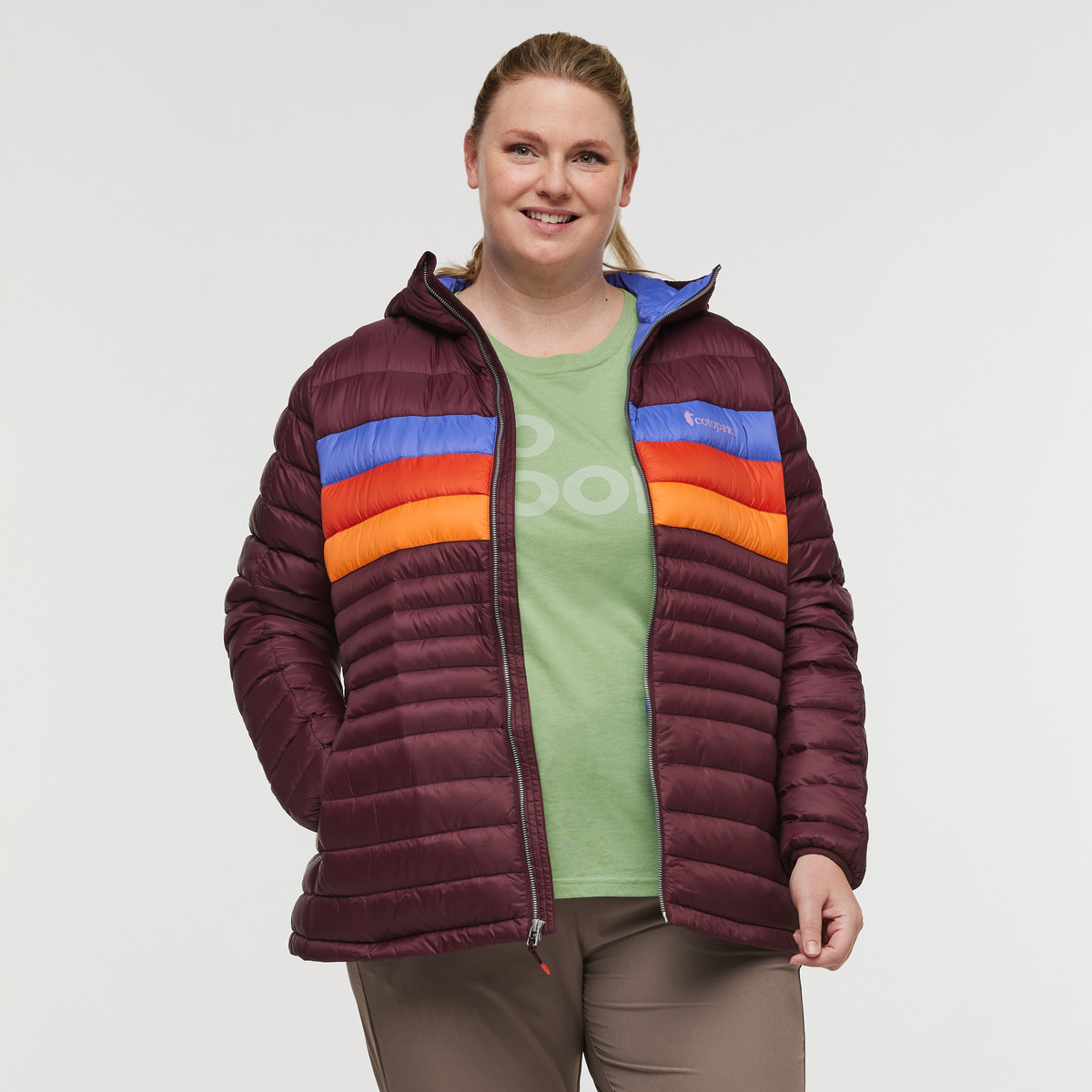 Front view with zipper down of plus size woman wearing Cotopaxi Fuego Down Plus Size Hooded Jacket in Wine Stripes