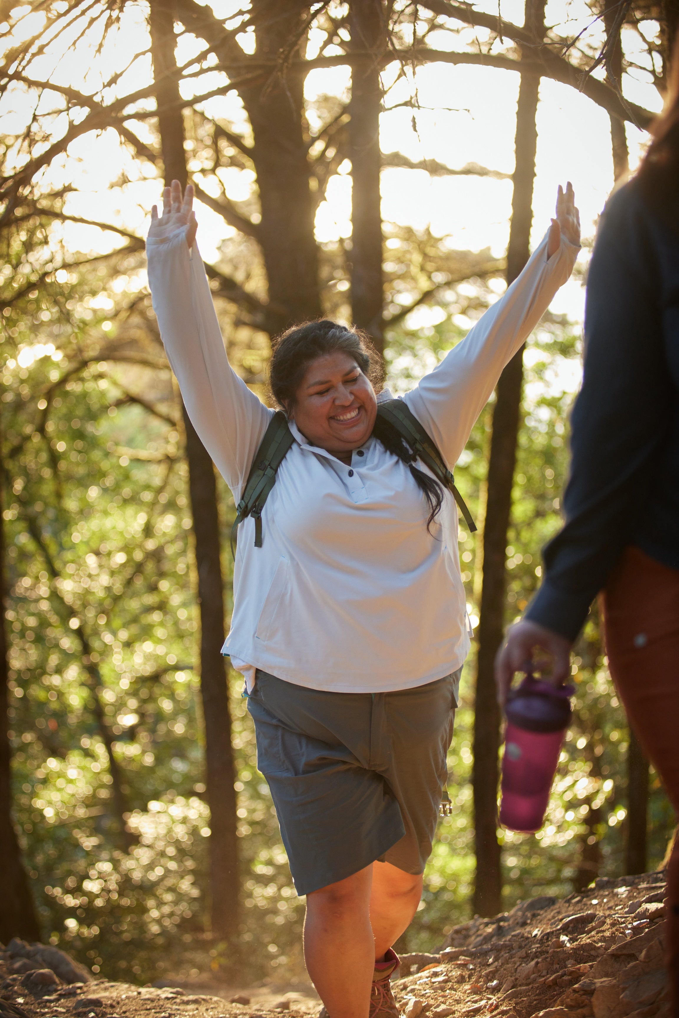 Plus Size Women Holding Up her arms wearing Alpine Parrot Shorts and Sun Shirt