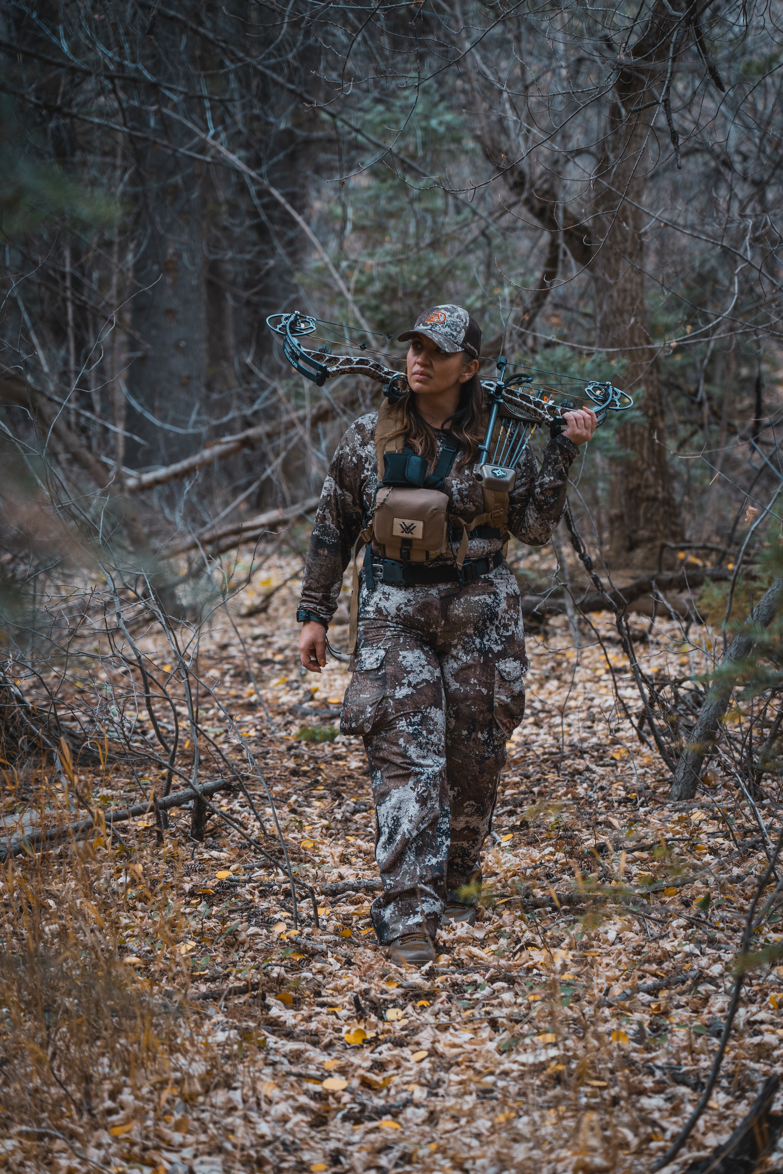 Woman walking in the woods wearing Ditale Hunting Gear