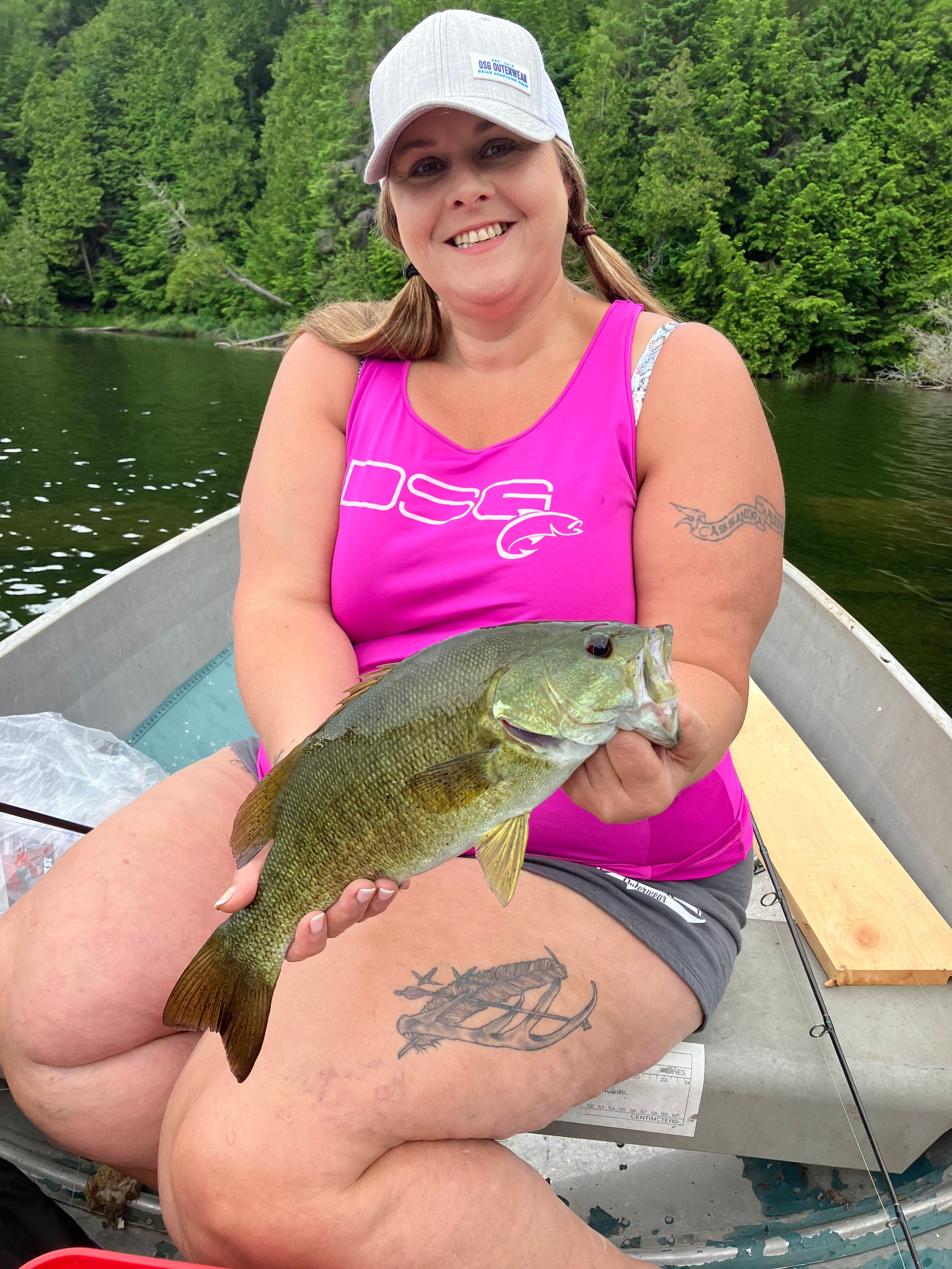 Kinsa Family Toni Cooper holding a fish she just caught in a boat