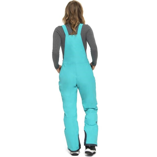 Woman wearing  Arctix black snow bibs in Bluebird