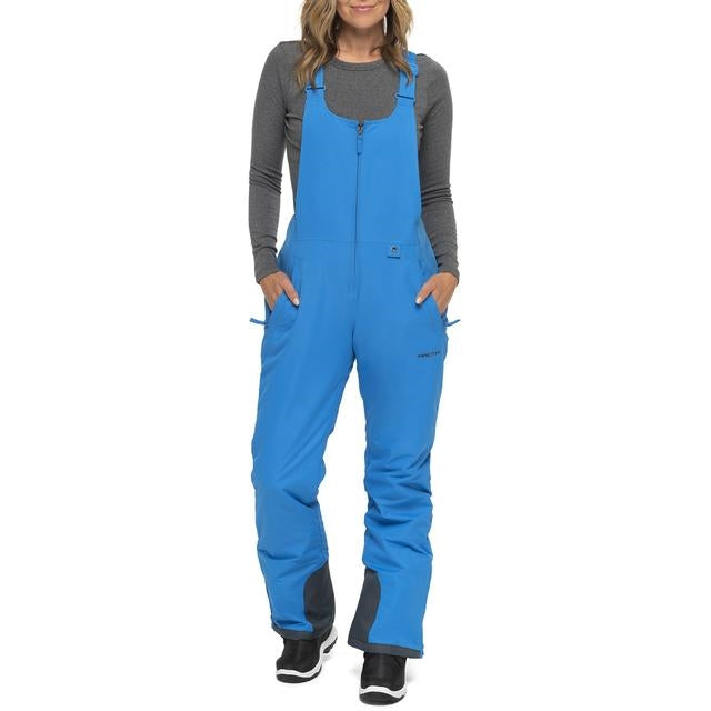Woman wearing Arctix snow bibs in Marine Blue 