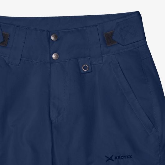 Close up view of woman wearing Arctix Plus Size Snow Pants pocket in blue night