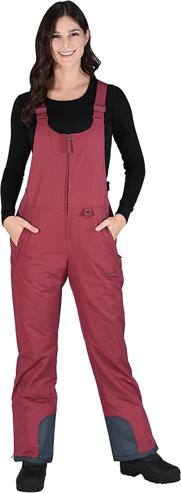 Front view of woman wearing Arctix snow bibs in crimson