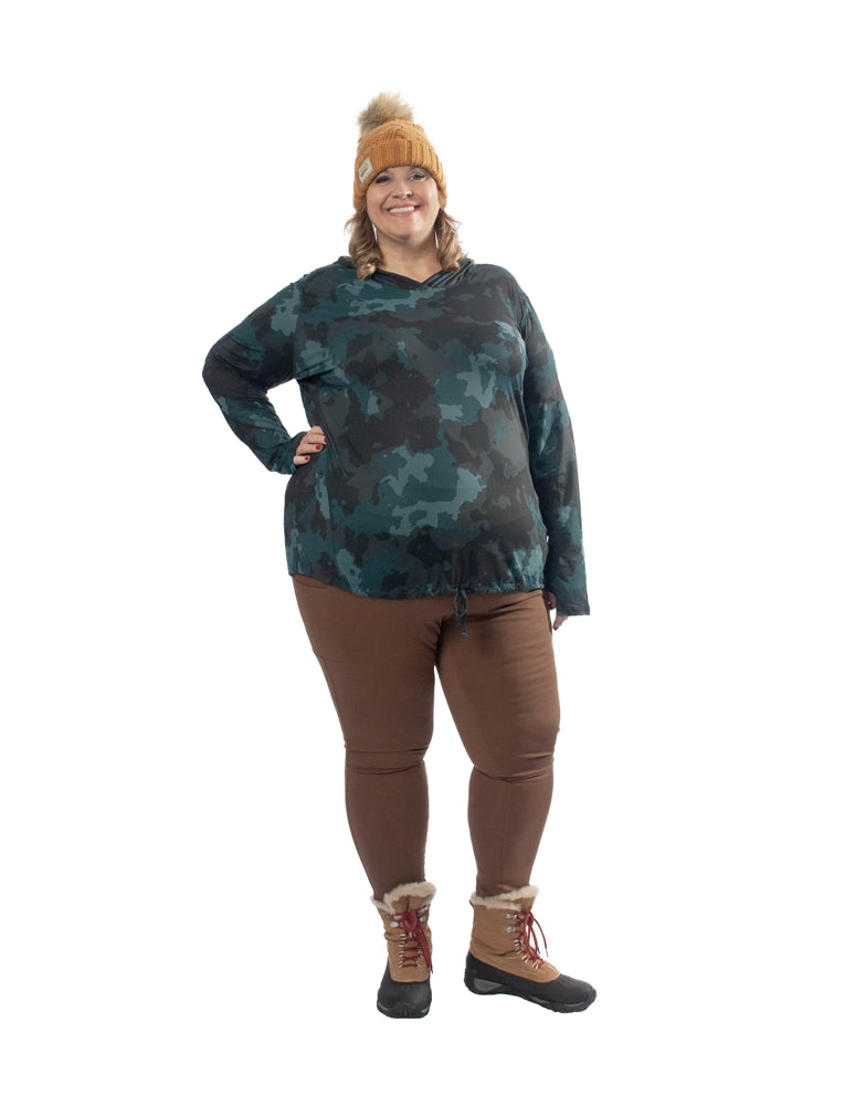 Plus size woman with hand on hip wearing the Mountain Hardwear Crater Lake Plus Size LS Hoody in Dark Marsh Pines Camo