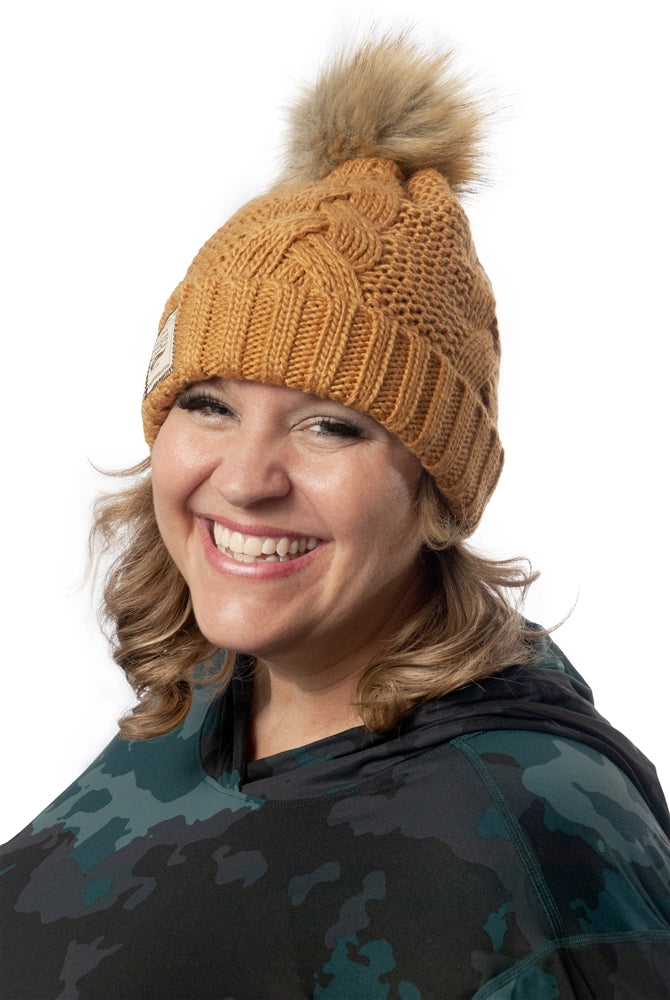 Kindra wearing a yellow beaning and the Mountain Hardwear Crater Lake Plus Size LS Hoody in Dark Marsh Pines Camo